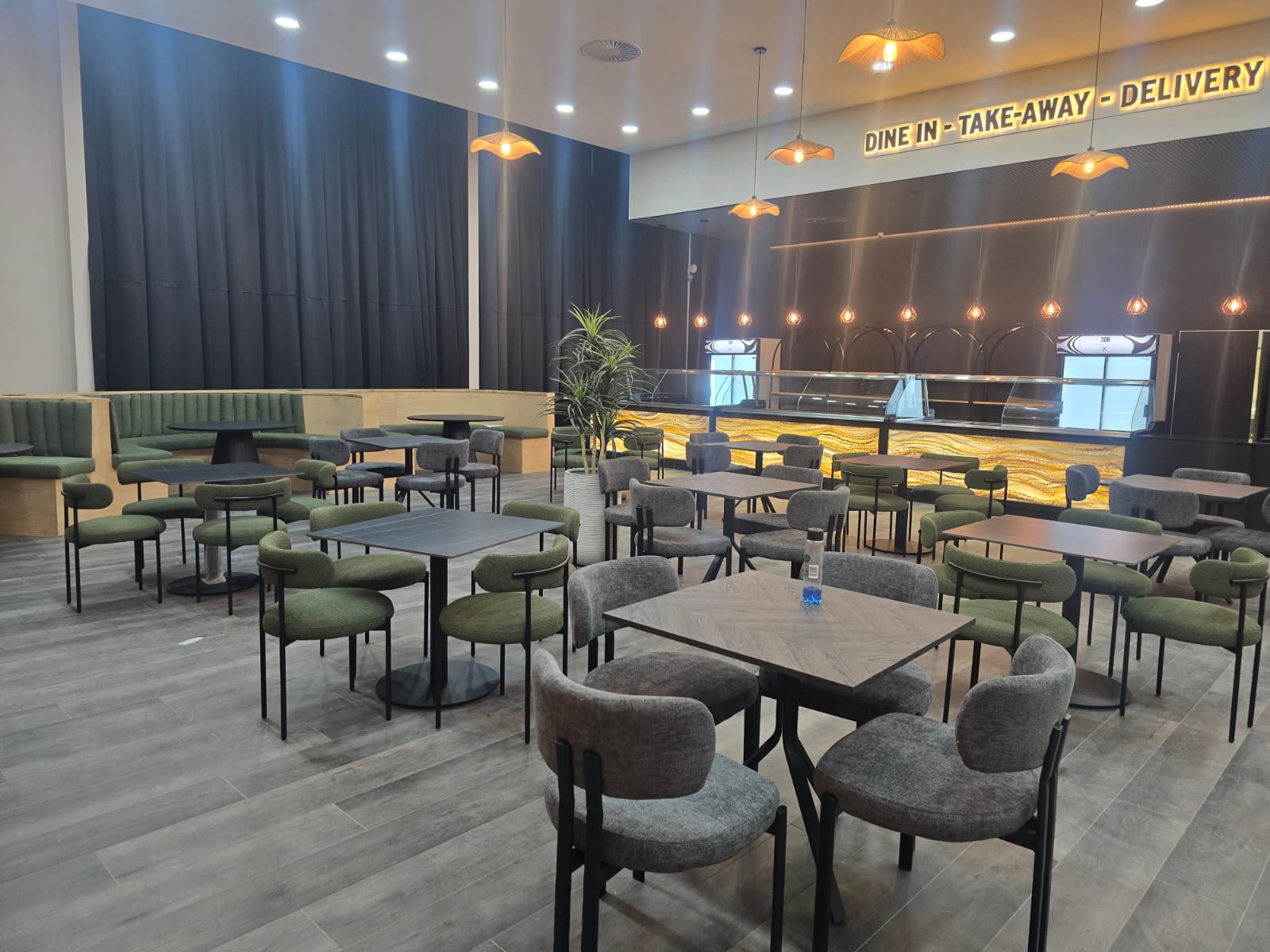 Completed restaurant fit-out with suspended ceiling, bulkhead and feature lighting