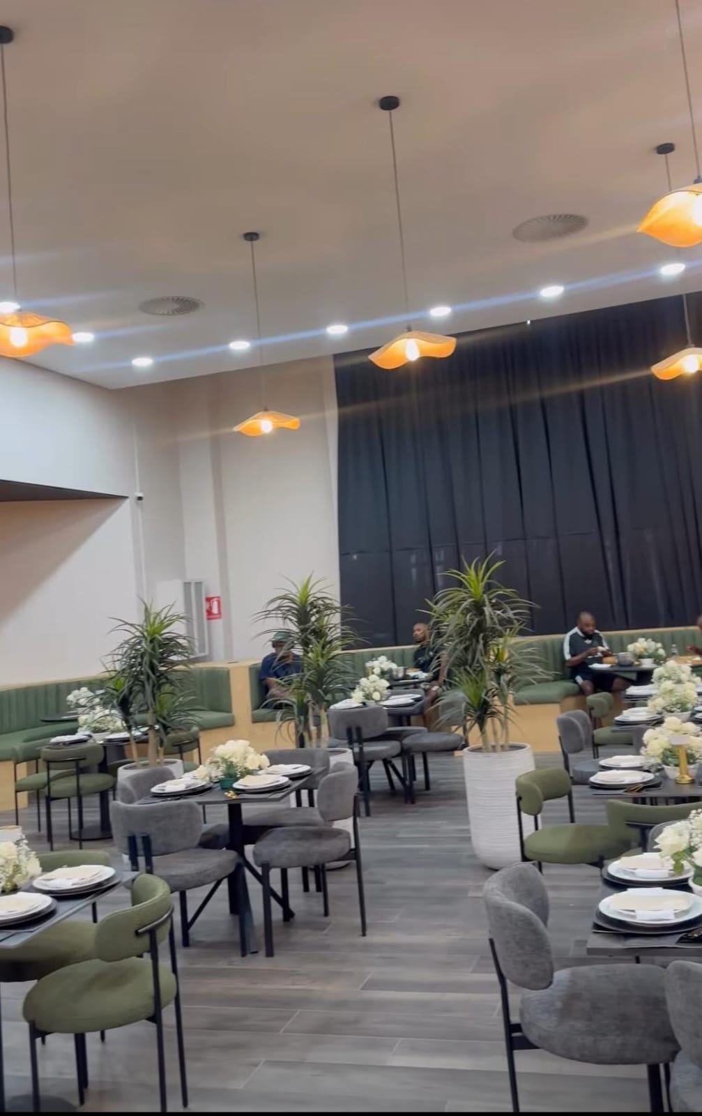 Finished restaurant interior with a suspended ceiling, recessed downlights and pendant lighting